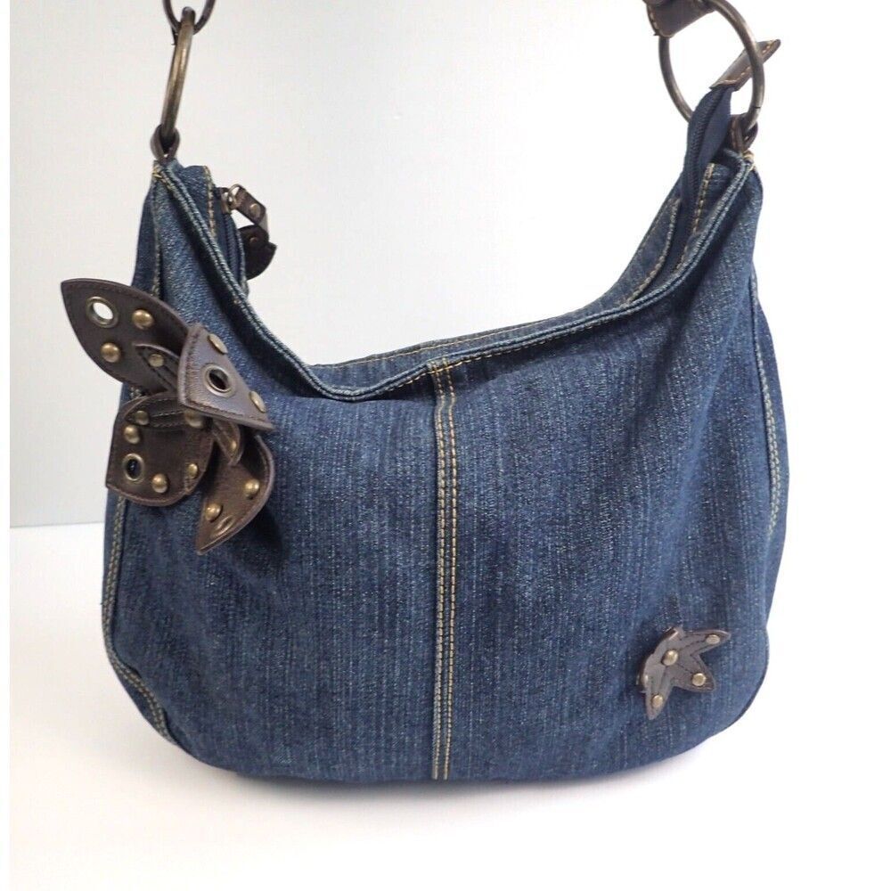 Denim crossbody bag w/faux brown leather flowers & brass grommet & stud deco.